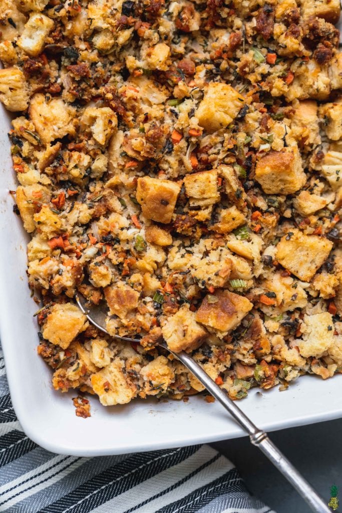 Closeup shot of a buttermilk biscuit thanksgiving stuffing with vegetables and herbs by sweetsimplevegan