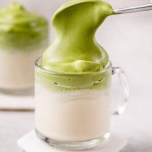 straight forward macro image of dalgona matcha latte with spoon