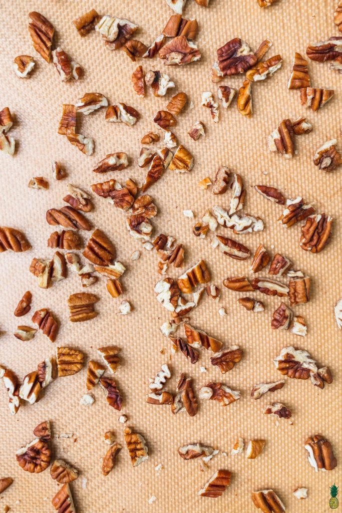Overhead shot of pecans on a baking sheet to be roasted