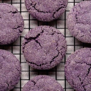 vegan ube sugar cookies on a black cooling rack