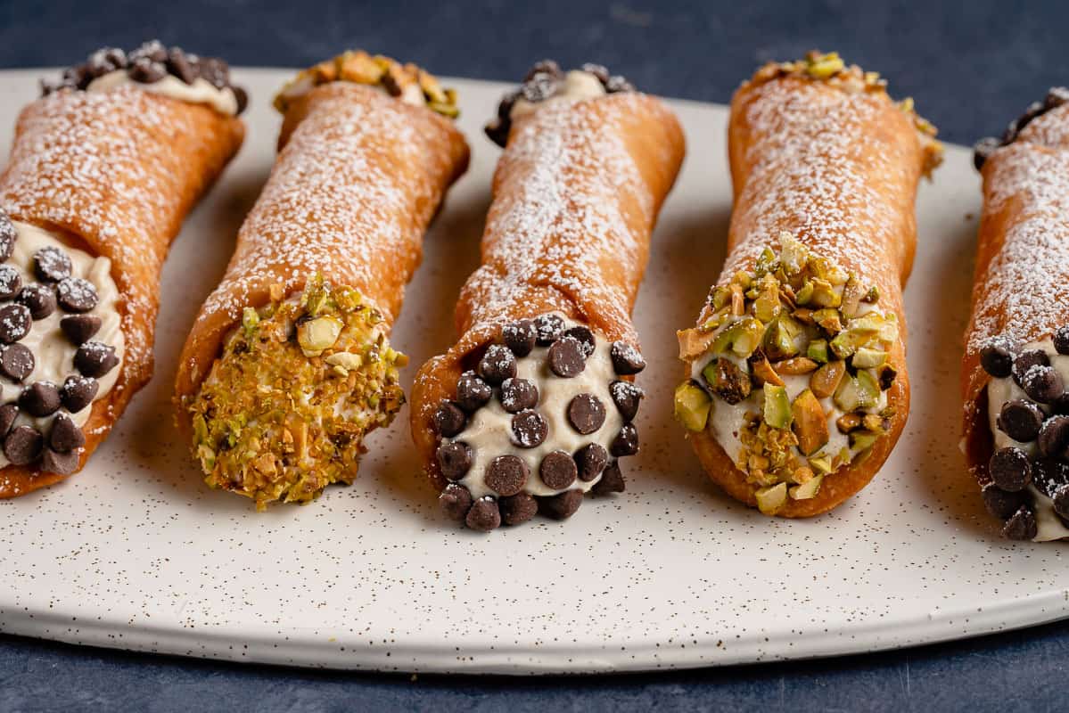 horizontal photo of Vegan Cannoli with Chocolate and Pistachios on white plate