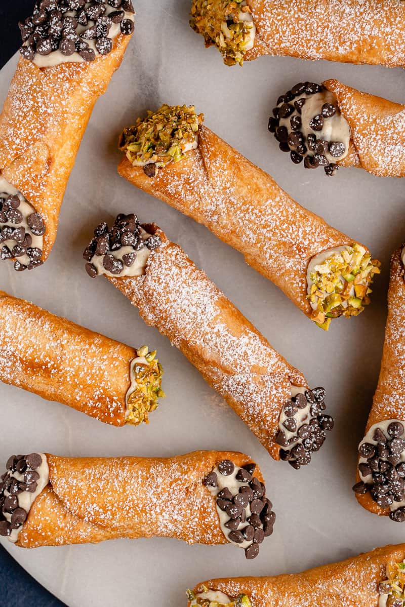 vertical photo of Vegan Cannoli with Chocolate and Pistachios on white plate