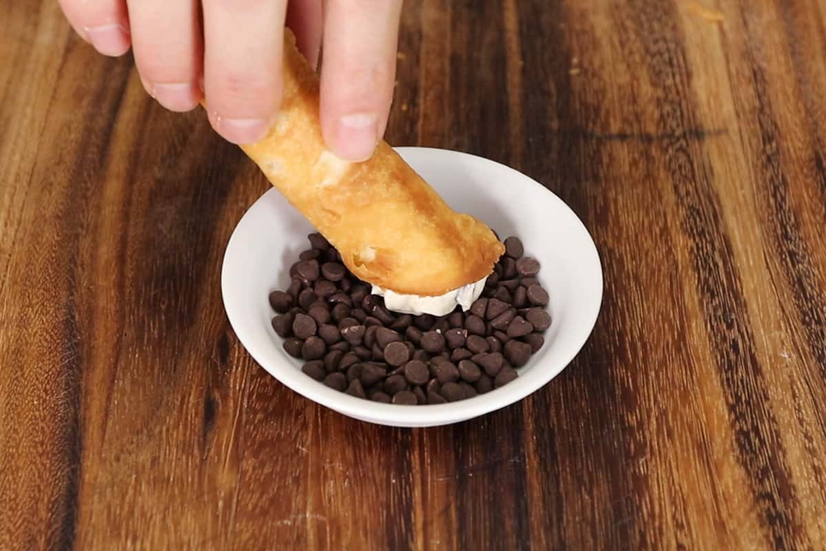 horizontal photo of step by step Vegan Cannoli with Chocolate and Pistachios on white plate