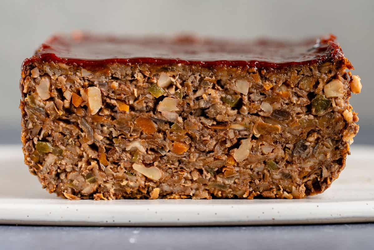 horizontal close up photo of vegan meatloaf made with lentils and vegetables