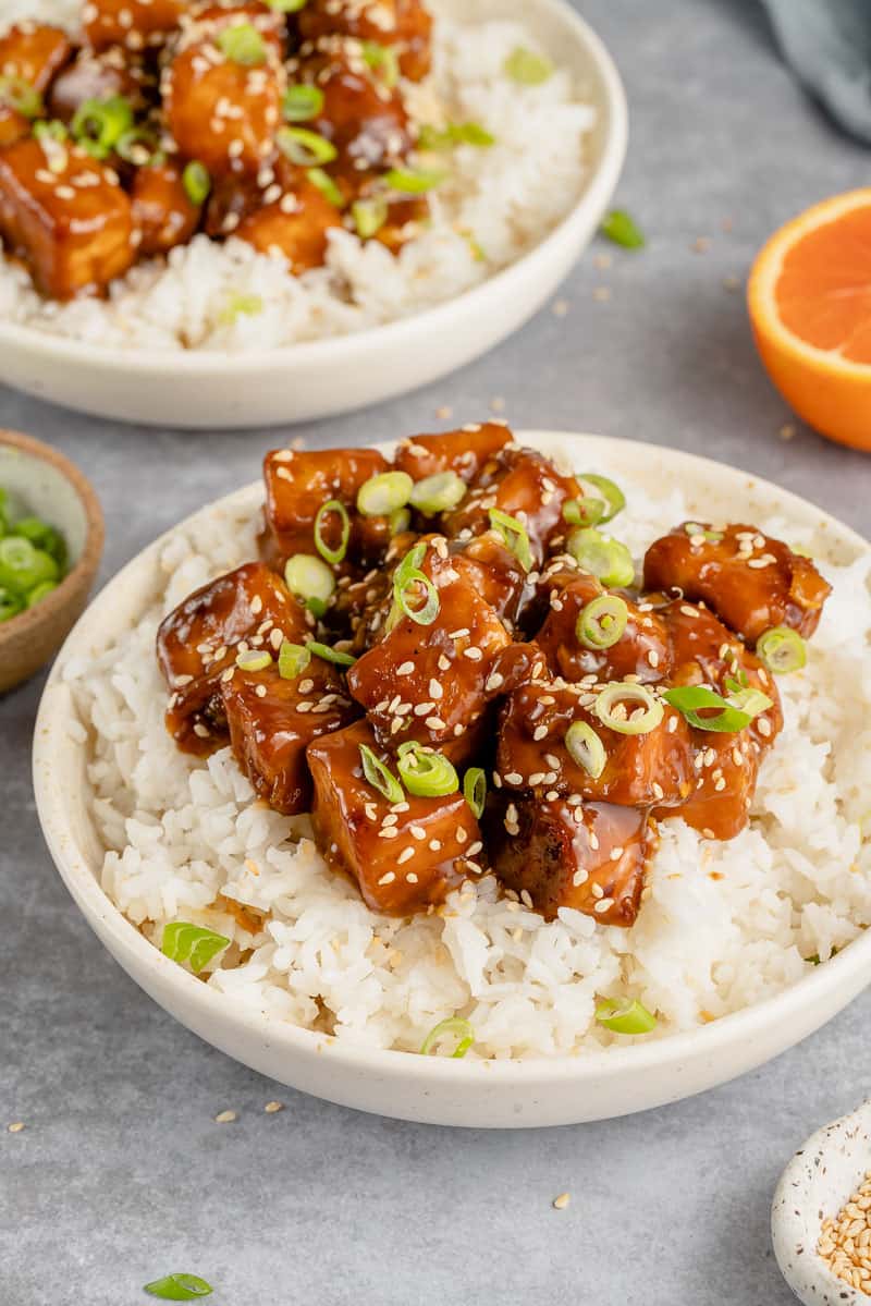 saucy vegan orange tofu in a bowl with rice
