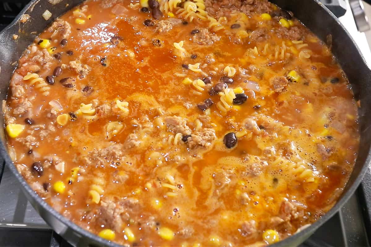 making vegan taco pasta in black pan