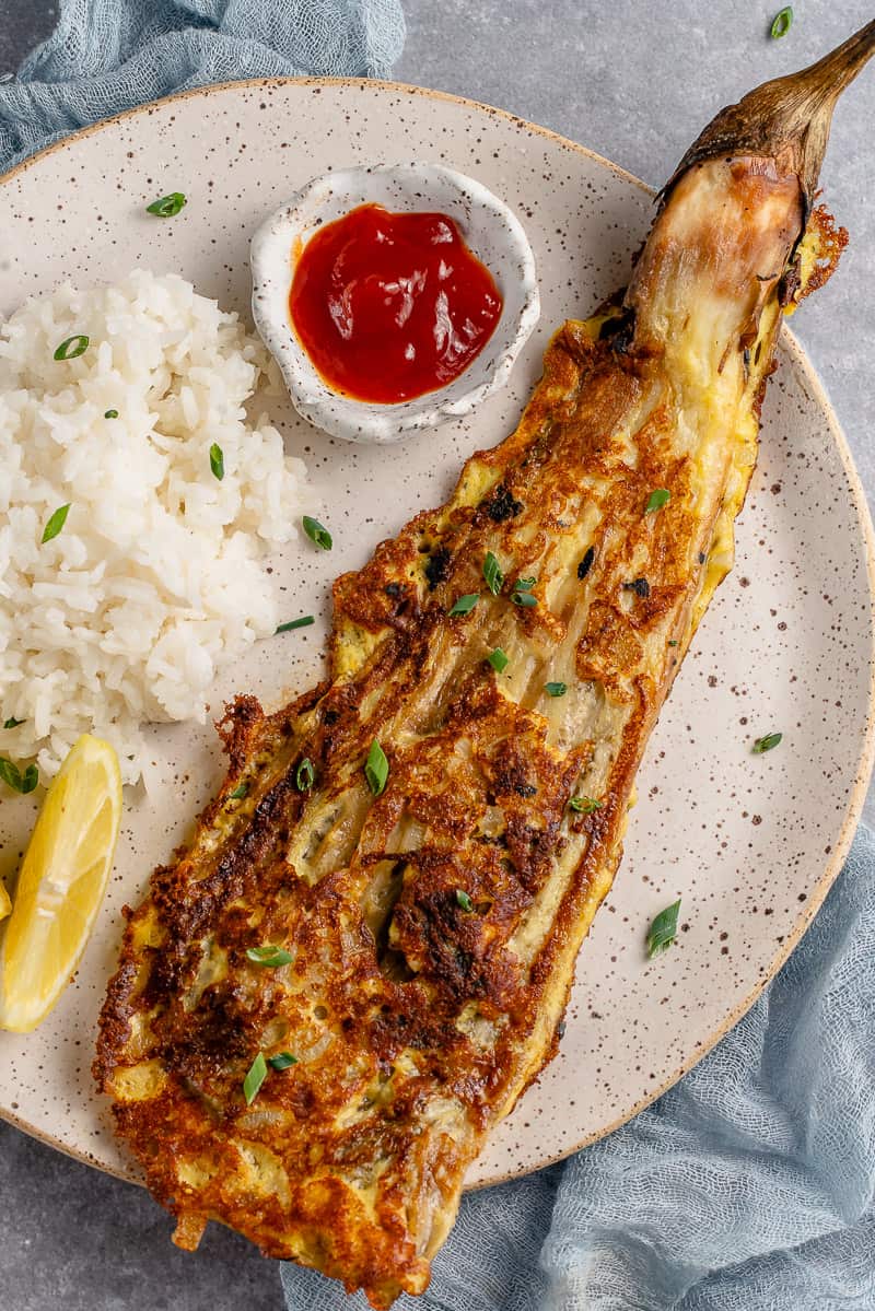 close up of white plate with vegan tortang talong, rice and banana ketchup